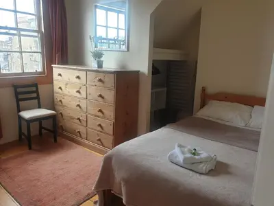 a bedroom with a bed and a dresser at Rose Street 2 bedroom in Edinburgh