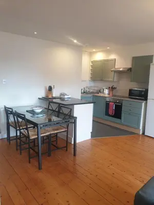 a kitchen with a table and chairs in a room at Rose Street 2 bedroom in Edinburgh