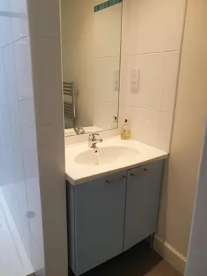 a bathroom with a sink and a mirror at Rose Street 2 bedroom in Edinburgh