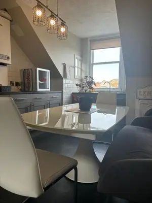a kitchen with a glass table with a plant on it at Golfers Rest in Ayr