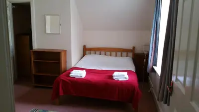 a bedroom with a bed with two towels on it at Rose Street 4 bedroom in Edinburgh