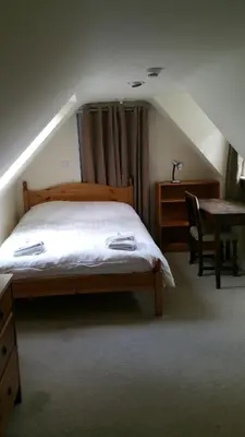 a bedroom with a bed and a desk and a table at Rose Street 4 bedroom in Edinburgh