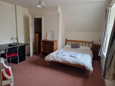 a bedroom with a bed and a desk and a chair at Rose Street 4 bedroom in Edinburgh