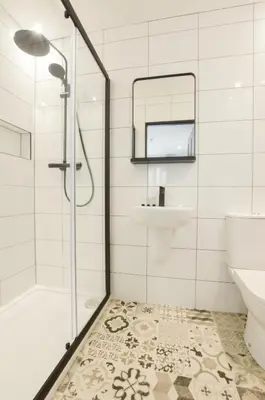a bathroom with a shower and a sink and a mirror at The Righ in Oban