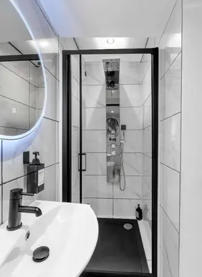 a bathroom with a white sink and a shower at The Bayview, Rothesay, Isle of Bute in Rothesay