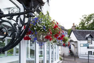 a hanging basket filled with flowers on a building at The Inveraray Inn, BW Signature Collection in Inveraray