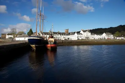 two boats are docked in a body of water at The Inveraray Inn, BW Signature Collection in Inveraray