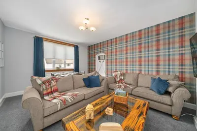 a living room with a couch and a table at Royal Troon Golf Let in Troon
