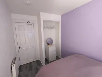 a bedroom with a bed and a white door at 4 bedroom Townhouse Greenock in Greenock