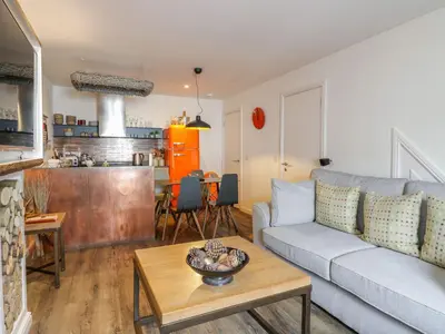 a living room with a couch and a table at Wee Cottage in Moffat