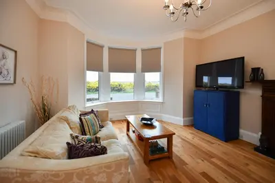 a living room with a couch and a flat screen tv at Arran View in Prestwick in Prestwick