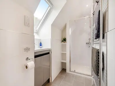 a bathroom with a shower and a glass door at Riverbank in Lamlash