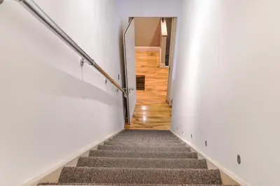 a staircase in a building with white walls and wooden floors at The Old School in Dean Village in Edinburgh