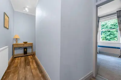 an empty room with a white wall and a window at GuestReady - Lovely nest in the Old Town in Edinburgh