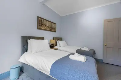 a bedroom with two beds with towels on them at GuestReady - Lovely nest in the Old Town in Edinburgh