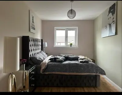 a bedroom with a bed and a window at Beautiful house in Clydebank in Glasgow