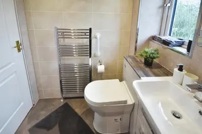 a bathroom with a white toilet and a sink at Beautiful house in Clydebank in Glasgow