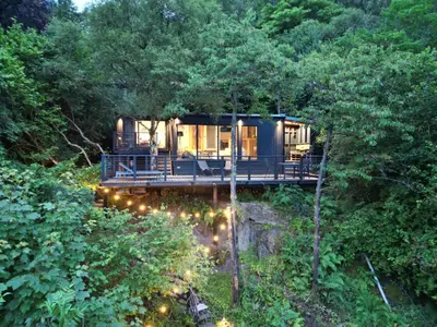 a tree house in the middle of the forest at Cherrybrae Cottage in Saint Fillans