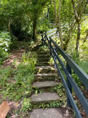 a set of stone stairs next to a fence at Cherrybrae Cottage in Saint Fillans
