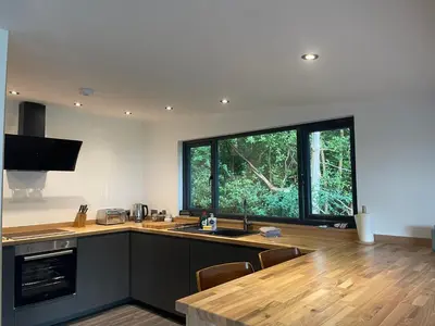 a kitchen with a counter and a large window at Cherrybrae Cottage in Saint Fillans