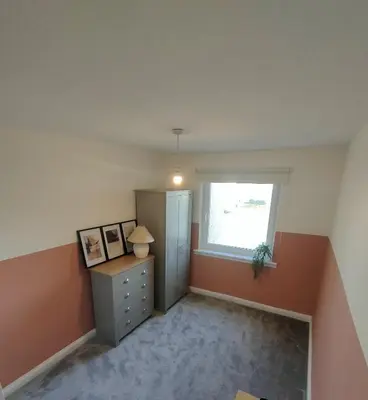 an empty room with a dresser and a window at Troon Golf and Beach House in Troon