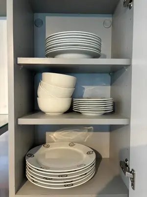 a cabinet filled with plates and bowls and dishes at Golf View in Prestwick