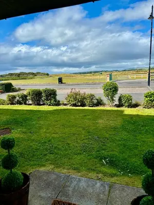 a park with a green lawn and a road at Golf View in Prestwick