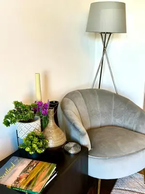 a living room with a chair and a table at Golf View in Prestwick