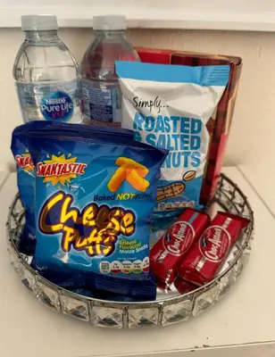 a basket of snacks and drinks on a counter at Haymaeket Centro Edinburgh in Edinburgh