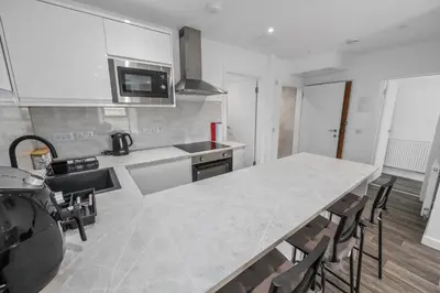 a kitchen with a large marble table and chairs at Cosy & Comfortable 2BR in Oban - Walk to Waterfront in Oban