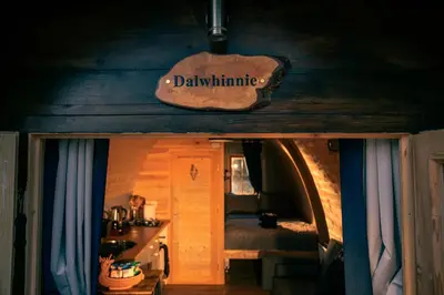 a room with a bed and a sign that says darmite at Green Oak Nature Retreat in Dunfermline