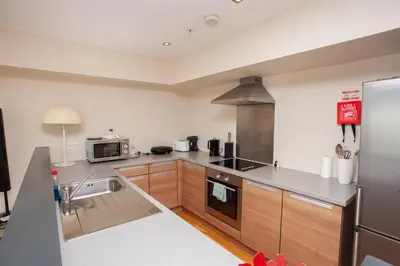 a kitchen with a sink and a stove at Beautiful Penthouse in City Centre Location in Glasgow