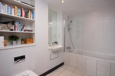 a bathroom with a shower and a toilet and a sink at Beautiful Penthouse in City Centre Location in Glasgow
