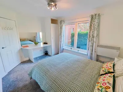 a bedroom with a bed and a window at La Casita, Quarry - 2 bedroom Entire Apartment with Free Parking in Glasgow
