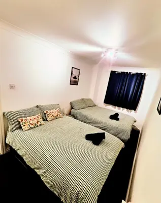 a bedroom with two beds and a window at La Casita, Quarry - 2 bedroom Entire Apartment with Free Parking in Glasgow
