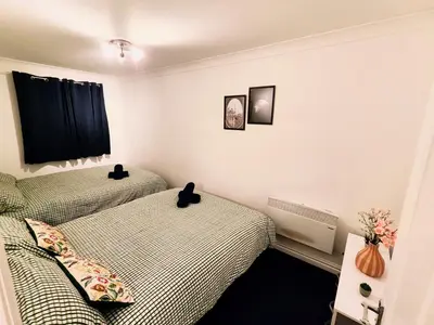 a bedroom with two beds and a window at La Casita, Quarry - 2 bedroom Entire Apartment with Free Parking in Glasgow