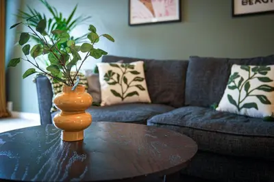 a table with a vase on top of a table at 2Bed City Central East End Gem with Free Parking in Glasgow