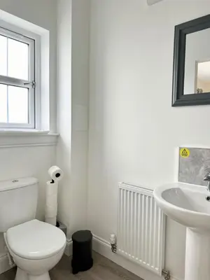 a white bathroom with a toilet and a sink at Edinburgh full house in Edinburgh