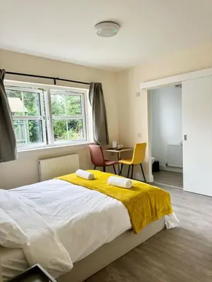 a bedroom with a large bed with a yellow blanket at Edinburgh full house in Edinburgh