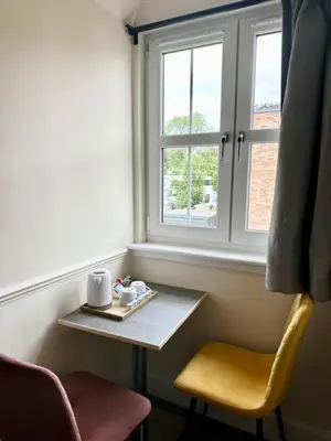 a table and two chairs and a window at Edinburgh full house in Edinburgh