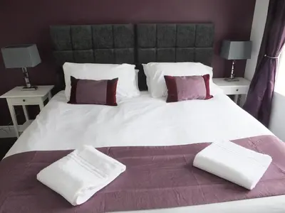 a large white bed with two pillows on it at Lochrin Apartments by Edinburgh City Apartments in Edinburgh