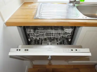 a dishwasher in a kitchen under a sink at Lochrin Apartments by Edinburgh City Apartments in Edinburgh