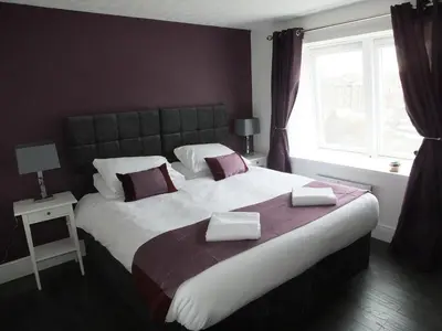 a bedroom with a large bed and a window at Lochrin Apartments by Edinburgh City Apartments in Edinburgh