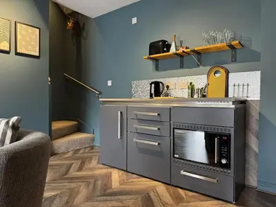 a kitchen with a sink and a stove at Stylish House with hot tub in Dalry