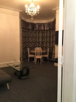 a dining room with a table and chairs and a chandelier at Beautiful 2 double bedrooms, 2 baths apartment in Port Glasgow