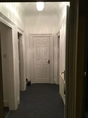 an empty hallway with a white door in a room at Beautiful 2 double bedrooms, 2 baths apartment in Port Glasgow