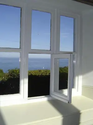 a white window with a view of the ocean at Coolranny Schoolhouse in Torr
