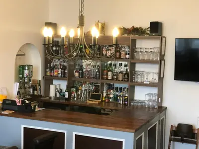 a bar with a chandelier hanging above it at St Ives Boutique Hotel in Dunoon