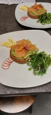 two plates of food with a sandwich on a table at St Ives Boutique Hotel in Dunoon
