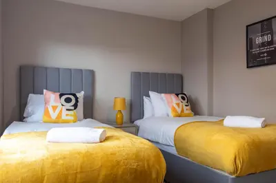two beds sitting next to each other in a room at Beth House in Bathgate